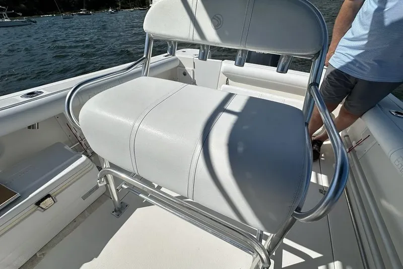 Slide: The Image of 2007 Edgewater 245CC boat with white seating and stainless steel frame on the deck. - 7