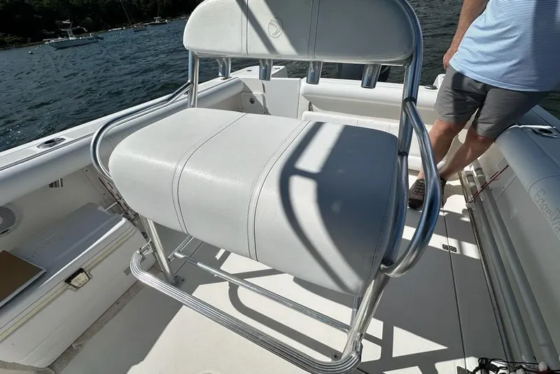 Slide: The Image of 2007 Edgewater 245CC boat interior with white seating and metal frame. - 8