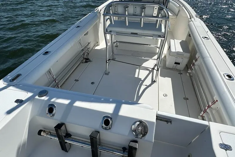 Slide: The Image of 2007 Edgewater 245CC boat interior with seating and storage, on open water. - 9