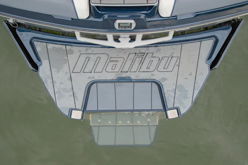 Slide: The Image of 2021 Malibu Wakesetter 23 MXZ swim platform on water, showcasing brand logo. - 10