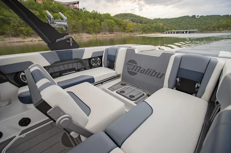Slide: The Image of 2021 Malibu Wakesetter 23 MXZ interior with stylish seating on a serene lake. - 12