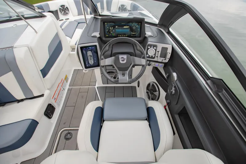 Slide: The Image of 2021 Malibu Wakesetter 23 MXZ boat interior with modern dashboard and steering wheel. - 15