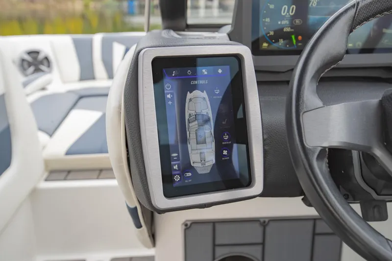 Slide: The Image of 2021 Malibu Wakesetter 23 MXZ dashboard with touchscreen controls and steering wheel. - 16