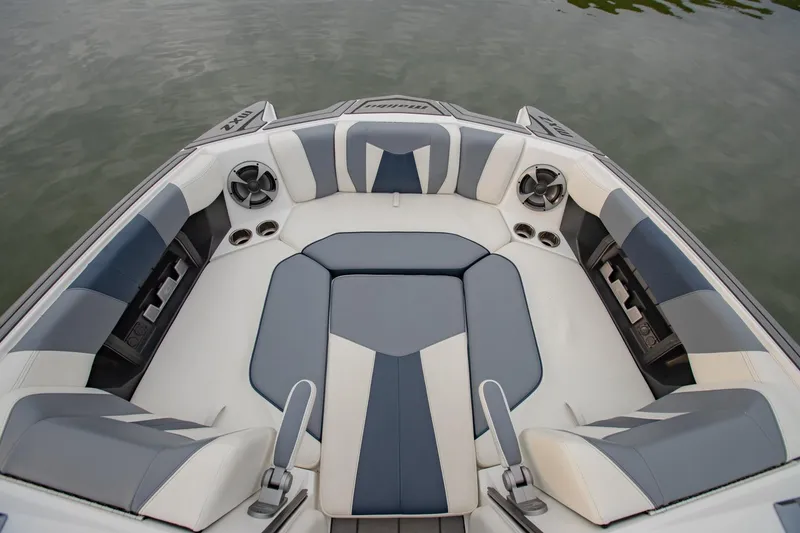Slide: The Image of 2021 Malibu Wakesetter 23 MXZ boat interior with gray and white seating. - 22