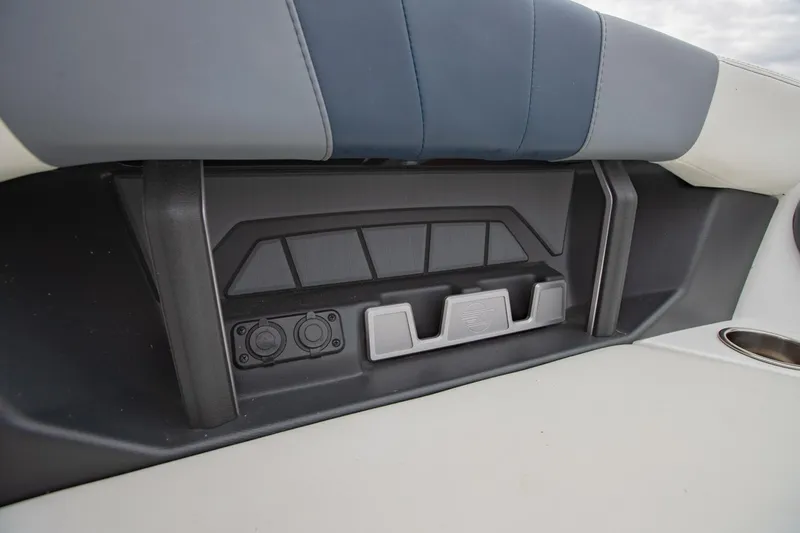 Slide: The Image of 2021 Malibu Wakesetter 23 MXZ interior detail with storage and cup holder. - 23