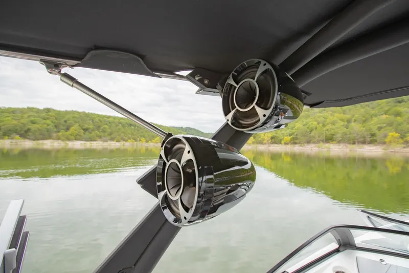 Slide: The Image of 2021 Malibu Wakesetter 23 MXZ boat speakers with scenic lake view. - 27