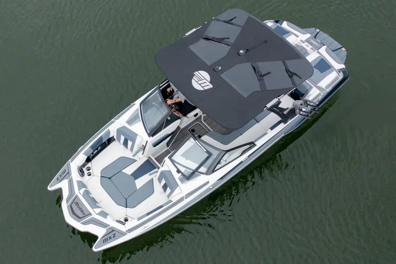 Slide: The Image of 2021 Malibu Wakesetter 23 MXZ boat on water, aerial view, sleek design, spacious seating. - 7