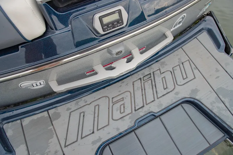 Slide: The Image of 2021 Malibu Wakesetter 23 MXZ boat deck with logo and control panel. - 8