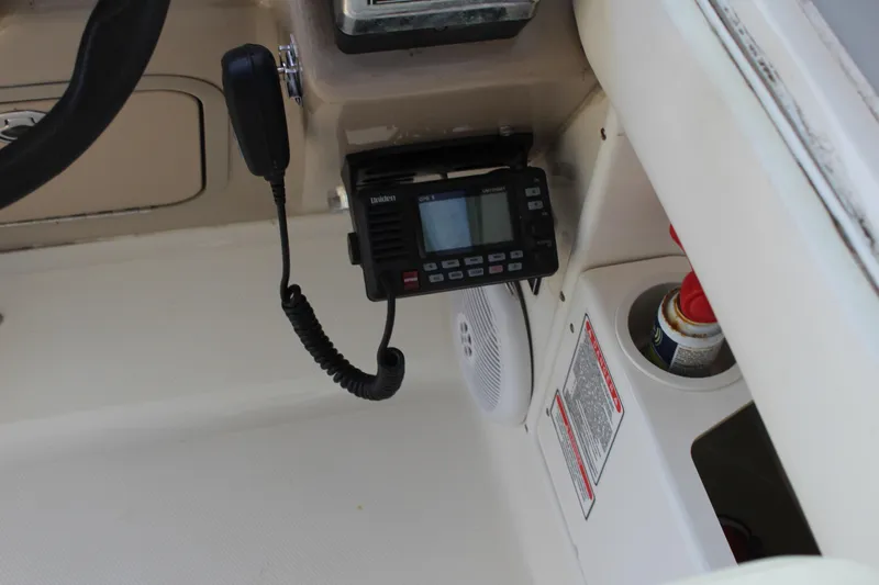 Slide: The Image of 2005 Sea Ray 300 Sundancer dashboard with radio and speaker system. - 14