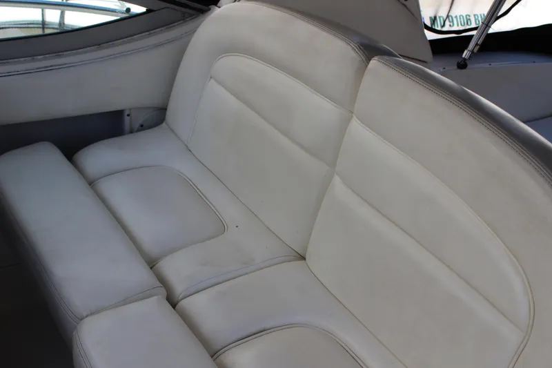 Slide: The Image of White leather seating on a 2005 Sea Ray 300 Sundancer boat interior. - 17