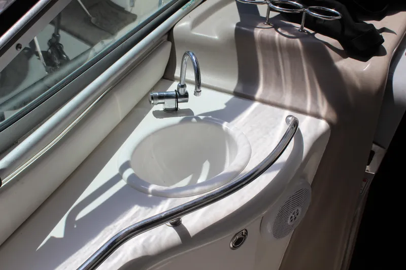 Slide: The Image of 2005 Sea Ray 300 Sundancer boat sink with chrome faucet and railing. - 18