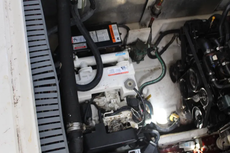 Slide: The Image of Engine compartment of a 2005 Sea Ray 300 Sundancer boat, showing mechanical components. - 25