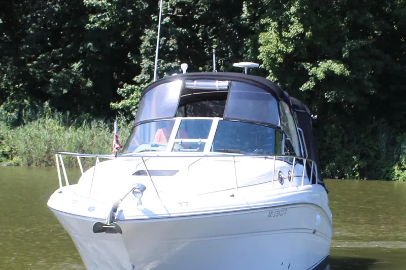 Slide: The Image of 2005 Sea Ray 300 Sundancer boat cruising on a calm river. - 5