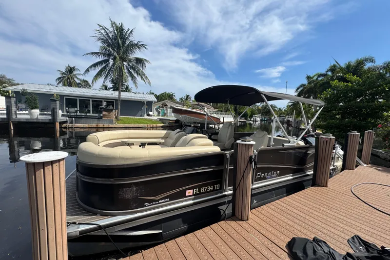 Slide: The Image of 2022 Premier Solaris 230 pontoon boat cruising on a sunny day, with scenic waterfront views. - 1