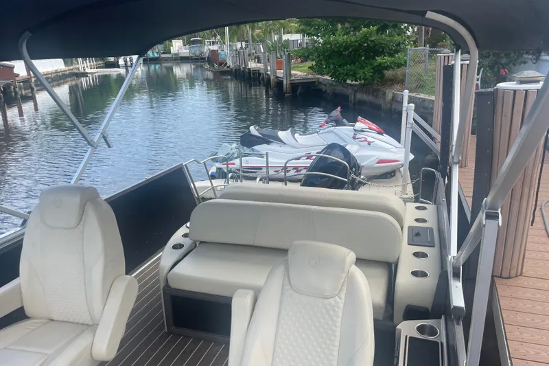 Slide: The Image of Interior of 2022 Premier Solaris 230 boat with beige seating and wooden flooring. - 10