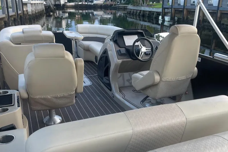 Slide: The Image of Premier Solaris 230 boat interior, 2022 model, featuring beige seating and cup holders. - 17