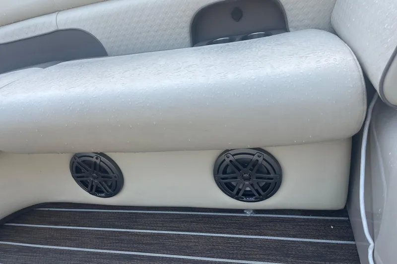 Slide: The Image of Premier Solaris 230 boat interior with beige seating and powerful outboard motor, 2022 model. - 21