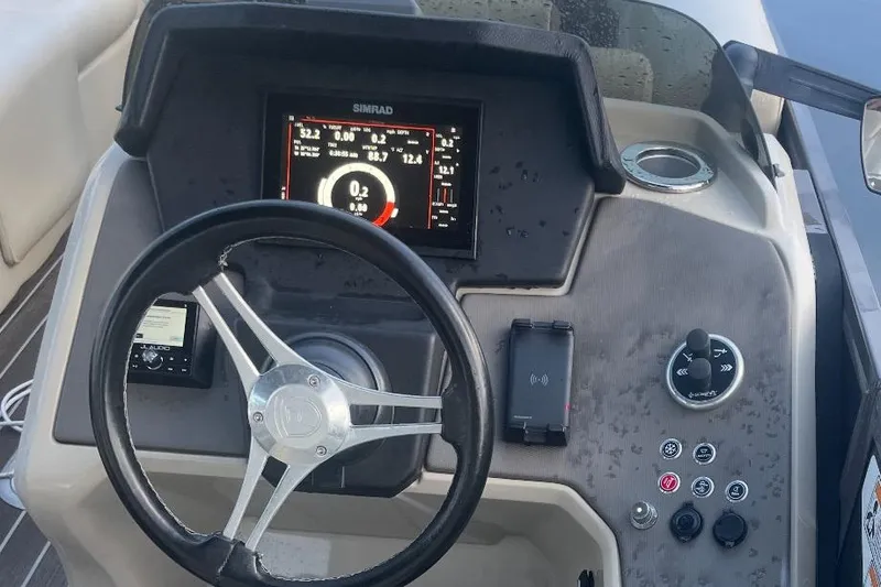 Slide: The Image of Premier Solaris 230 boat interior with cup holders and beige seating, 2022 model. - 23