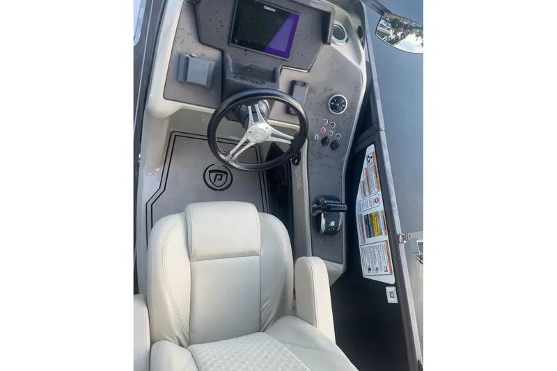 Slide: The Image of Luxurious seating on 2022 Premier Solaris 230 boat with cup holders and sleek design. - 24