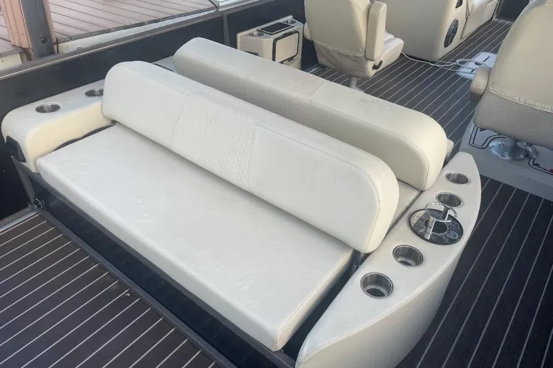 Slide: The Image of Premier Solaris 230 boat interior with speakers, 2022 model, featuring cushioned seating. - 26