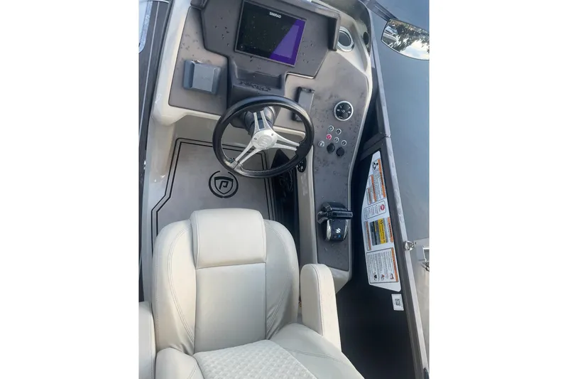 Slide: The Image of Premier Solaris 230 boat interior, 2022 model, featuring white seating and cup holders. - 31