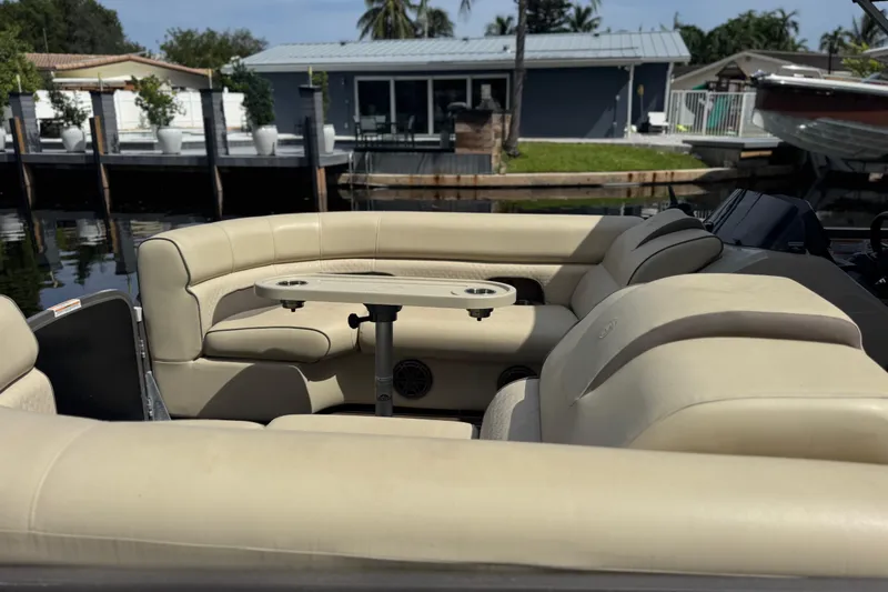 Slide: The Image of Outboard motor on Premier Solaris 230 boat, 2022 model, docked on wooden pier. - 34