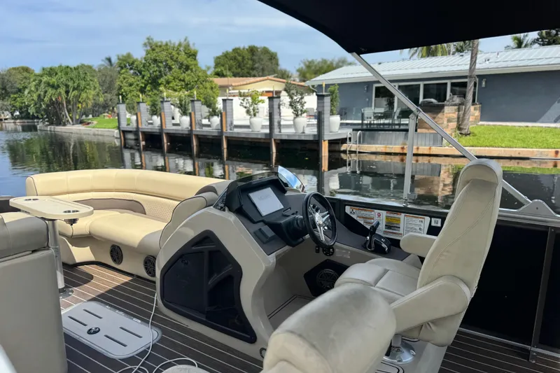 Slide: The Image of Interior of 2022 Premier Solaris 230 boat with steering wheel and control panel. - 36