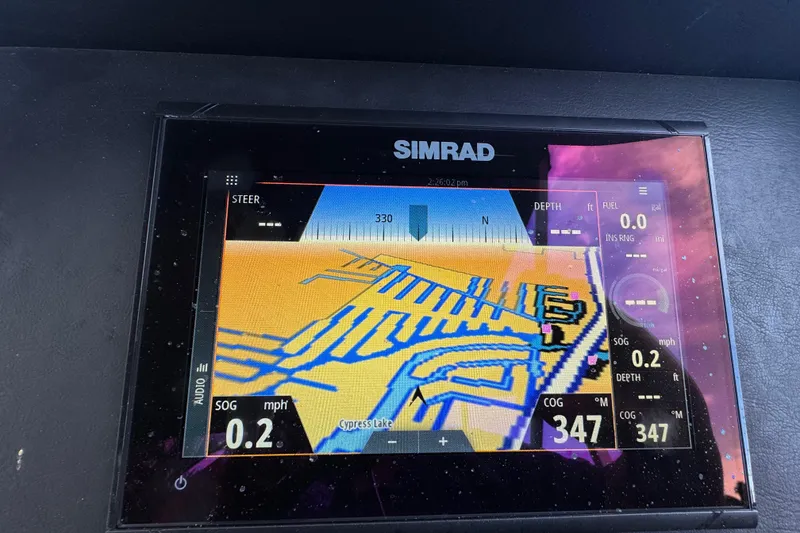 Slide: The Image of Premier Solaris 230 boat interior, 2022 model, docked by a serene canal with lush surroundings. - 39