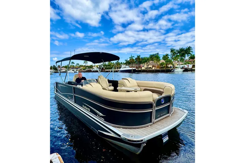 Slide: The Image of 2022 Premier Solaris 230 pontoon boat on a sunny day, featuring comfortable seating and canopy. - 78