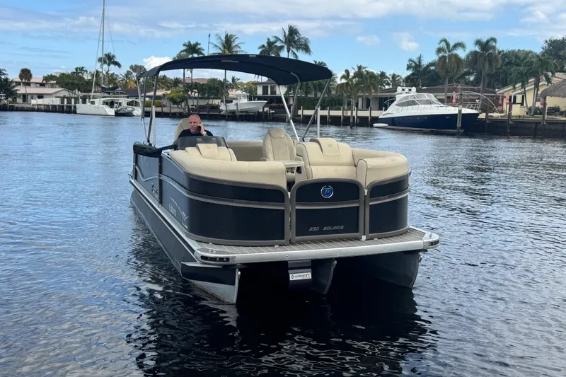 Slide: The Image of Premier Solaris 230 pontoon boat cruising on a scenic waterway, 2022 model. - 80