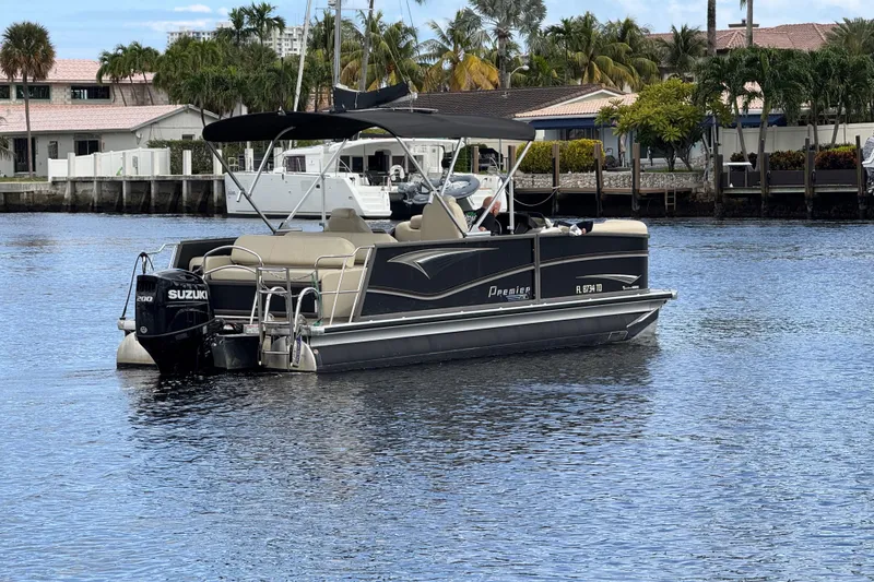 Slide: The Image of 2022 Premier Solaris 230 pontoon boat on water, featuring Suzuki outboard motor. - 81