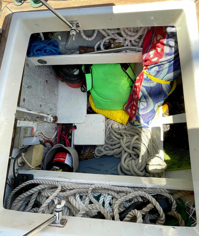 Slide: The Image of Storage compartment on a 1977 Aleutian 51 boat, filled with ropes and colorful gear. - 15