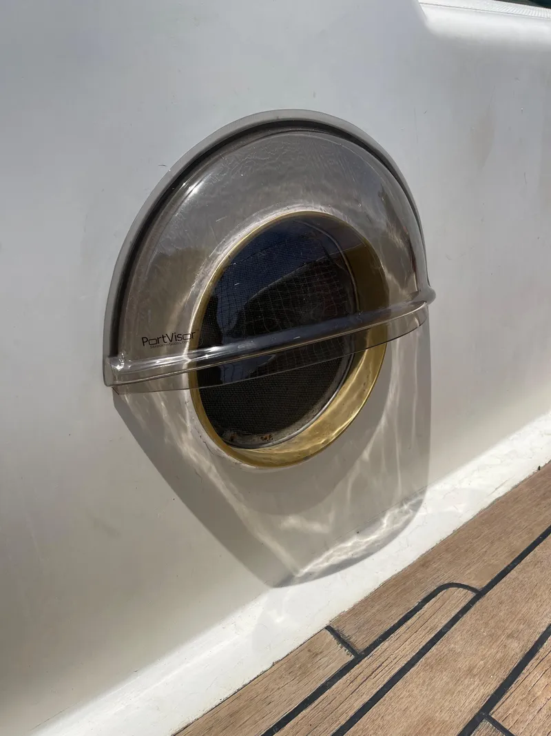Slide: The Image of Porthole on 1977 Aleutian 51 yacht with wooden deck detail. - 20