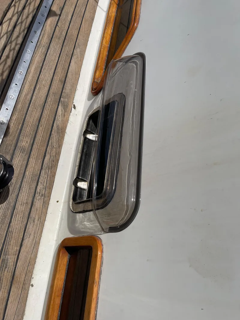 Slide: The Image of 1977 Aleutian 51 yacht deck with wooden trim and hatch detail. - 21