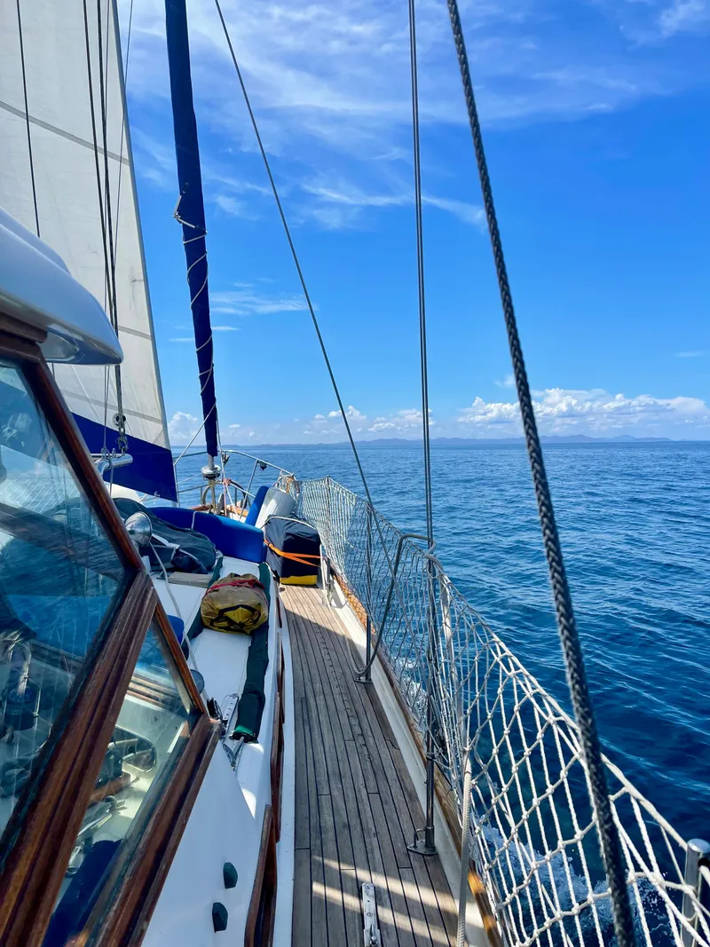 Slide: The Image of Sailing on a 1977 Aleutian 51 yacht under clear blue skies. - 22