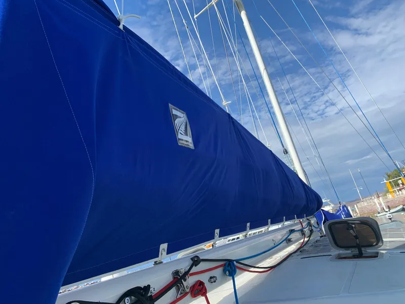 Slide: The Image of Blue sail cover on 1977 Aleutian 51 yacht under clear sky. - 27