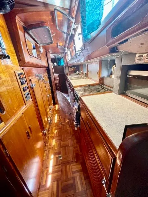 Slide: The Image of 1977 Aleutian 51 yacht interior with wooden cabinetry and parquet flooring. - 41