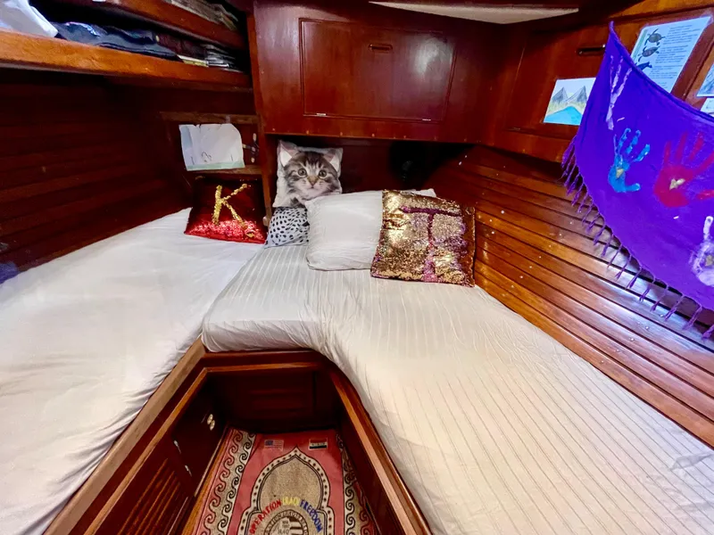 Slide: The Image of Cozy cabin interior of 1977 Aleutian 51 yacht with decorative pillows and wooden paneling. - 43