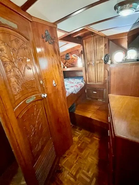 Slide: The Image of 1977 Aleutian 51 yacht interior with carved wood details and cozy sleeping area. - 47