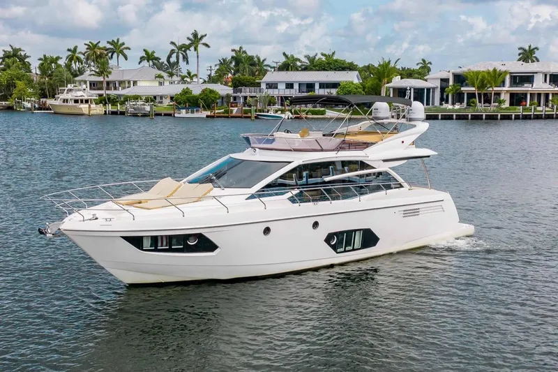 The Image of Luxury yacht Absolute 56 FLY 2015 cruising on a scenic waterfront. - 0