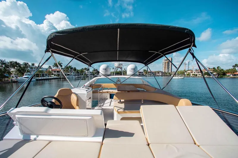 Slide: The Image of Luxurious 2015 Absolute 56 FLY yacht with spacious deck and canopy on serene water. - 11