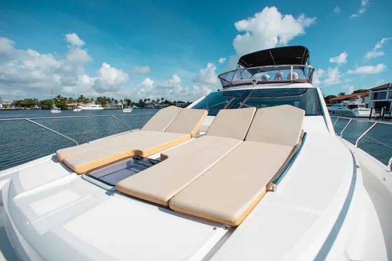 Slide: The Image of Luxurious 2015 Absolute 56 FLY yacht with sun loungers on deck, docked in a marina. - 15