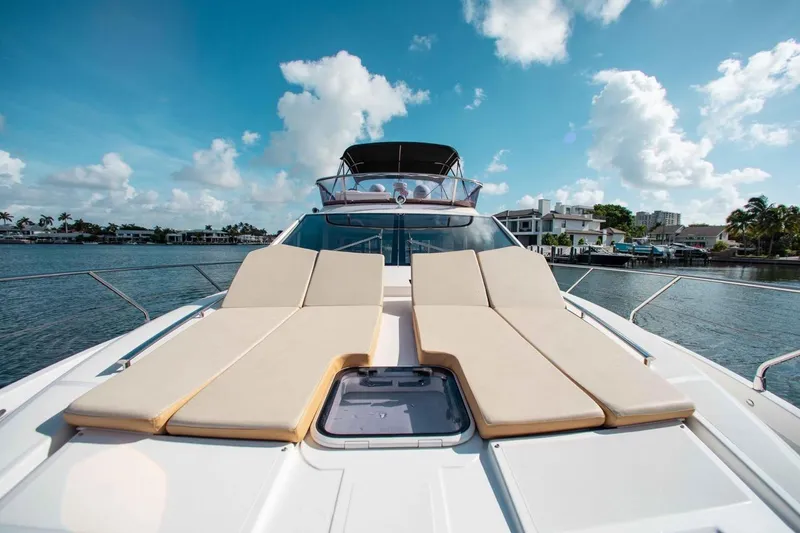 Slide: The Image of Luxurious 2015 Absolute 56 FLY yacht with sun loungers on deck, under a bright blue sky. - 16