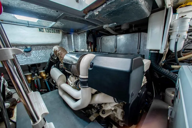 Slide: The Image of Engine room of a 2015 Absolute 56 FLY yacht, showcasing mechanical components. - 24