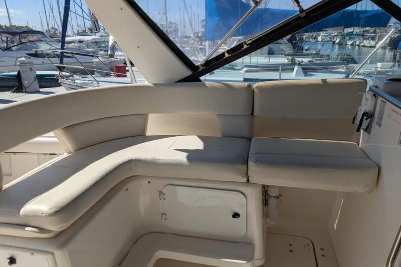 Slide: The Image of 1995 Tiara Yachts 3100 Open interior seating with marina view in background. - 19