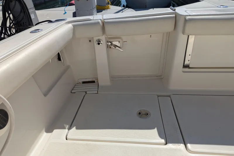 Slide: The Image of 1995 Tiara Yachts 3100 Open boat interior with cushioned seating and storage compartments. - 20