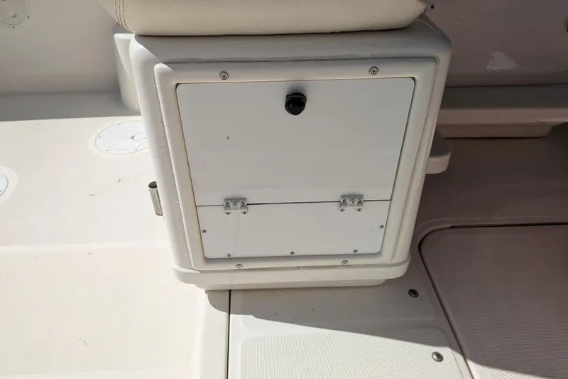 Slide: The Image of 1995 Tiara Yachts 3100 Open storage compartment with latch on deck. - 21