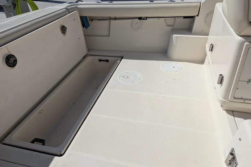 Slide: The Image of 1995 Tiara Yachts 3100 Open boat interior with storage compartment open. - 22