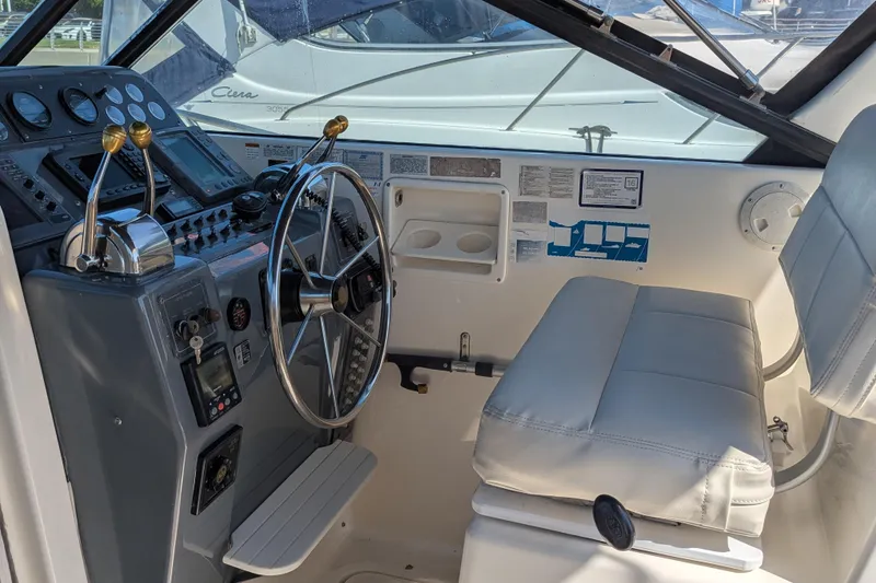 Slide: The Image of 1995 Tiara Yachts Tiara 3100 helm with steering wheel and control panel. - 23