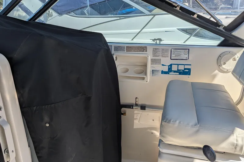 Slide: The Image of Interior of a 1995 Tiara Yachts 3100 Open, featuring seating and control panel. - 26